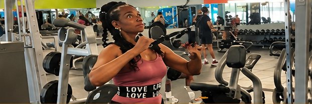 Jacqueline doing a cable chest exercise in the gym